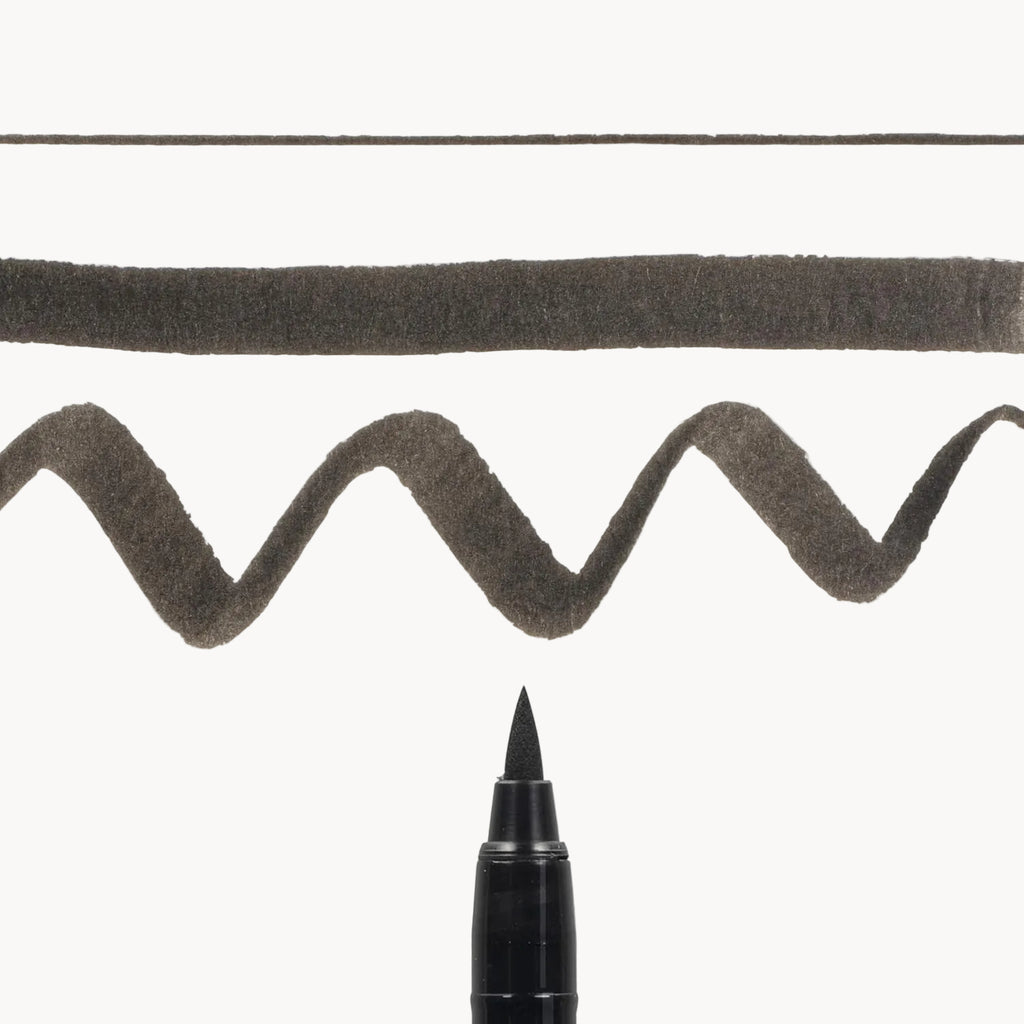 Calligraphy brush stroke demonstrating the line variation of the Pigma Medium Brush
